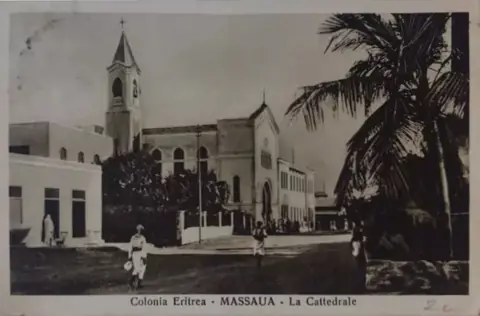 An old postcard of the cathedral at Massawa, a white church with a bell tower, from the Italian years